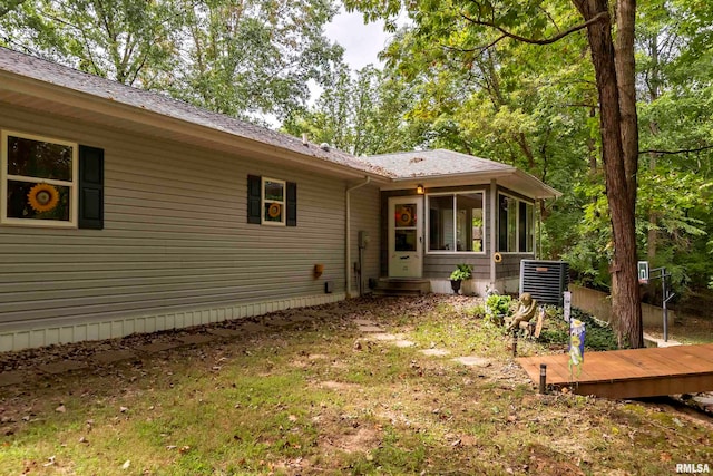 exterior space with a sunroom and central AC