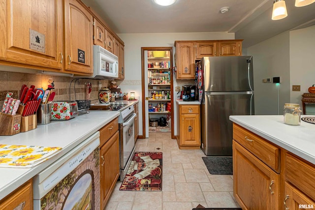 kitchen featuring decorative backsplash and white appliances