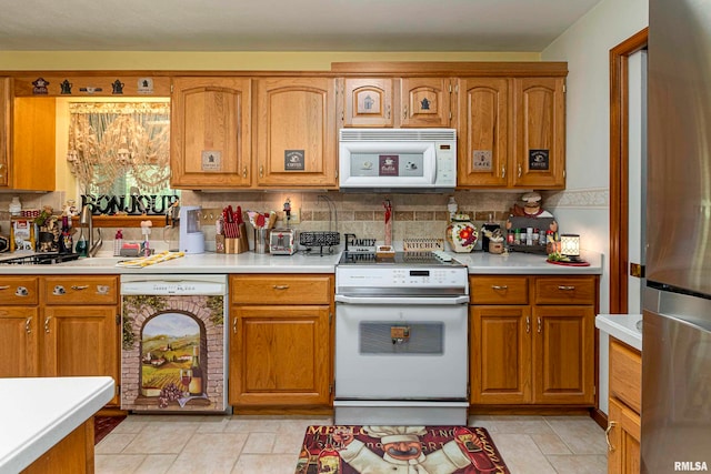 kitchen with white appliances, light tile patterned flooring, and tasteful backsplash