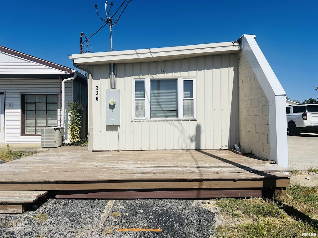 view of front of home featuring central AC and a wooden deck