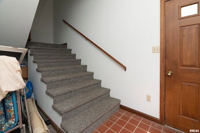 staircase featuring tile patterned floors