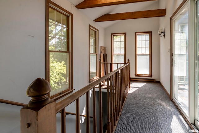 corridor with lofted ceiling with beams and light colored carpet