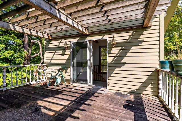 property entrance with a pergola and a deck