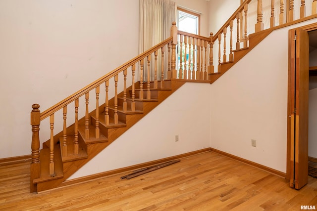 stairs featuring wood-type flooring