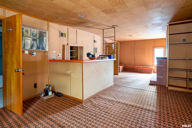 kitchen featuring a textured ceiling and carpet floors