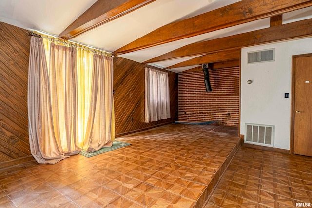 unfurnished living room with brick wall, vaulted ceiling with beams, wooden walls, and parquet flooring