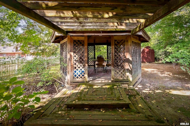 wooden terrace with a shed