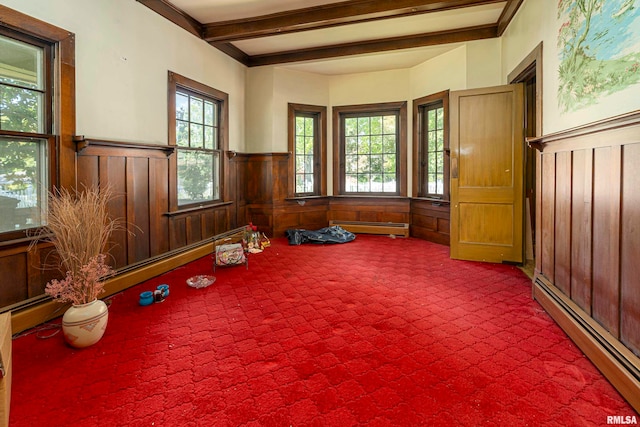 interior space with carpet floors, a baseboard heating unit, and beamed ceiling