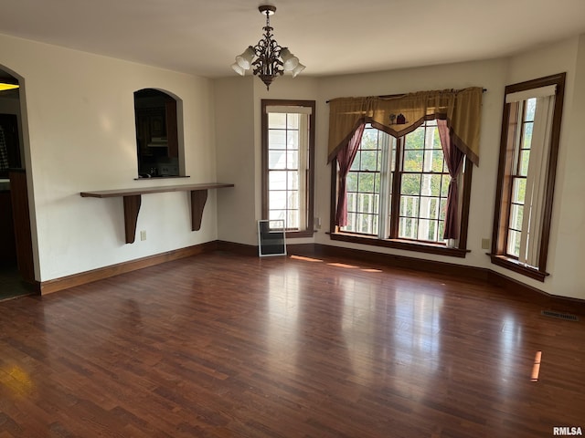 interior space featuring a chandelier and dark hardwood / wood-style flooring