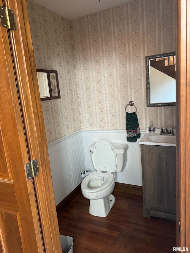 bathroom featuring vanity, toilet, and hardwood / wood-style floors