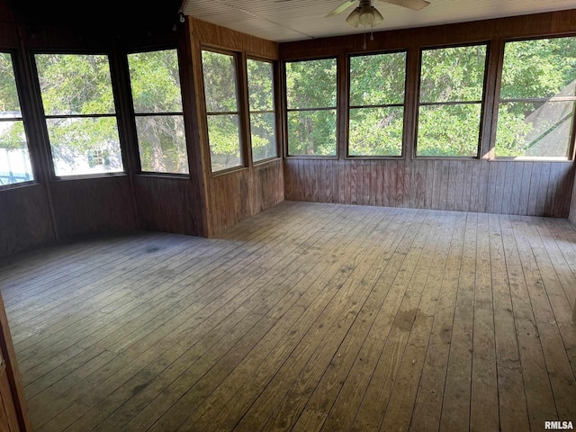 unfurnished sunroom featuring ceiling fan