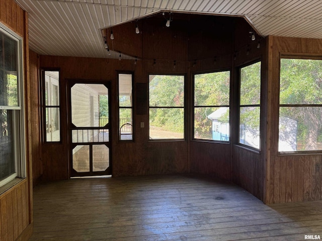 unfurnished sunroom featuring rail lighting and wooden ceiling