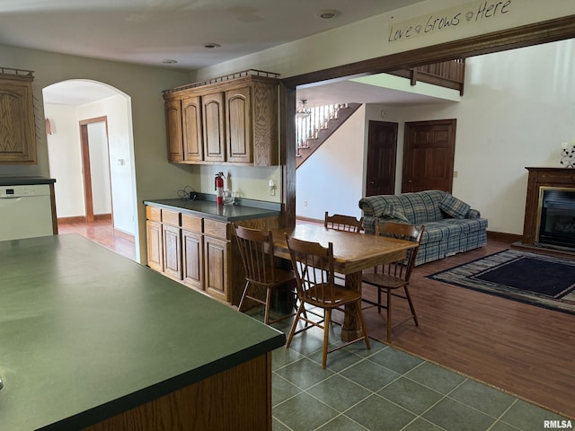 kitchen featuring white dishwasher and dark tile patterned flooring