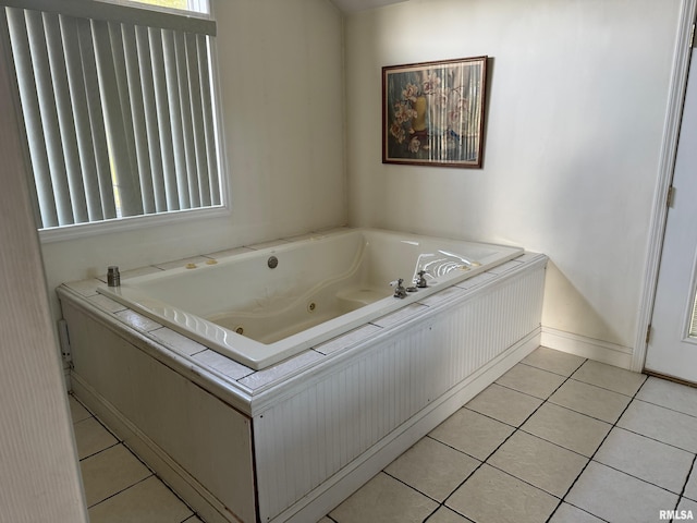 bathroom with tile patterned flooring and a bathing tub