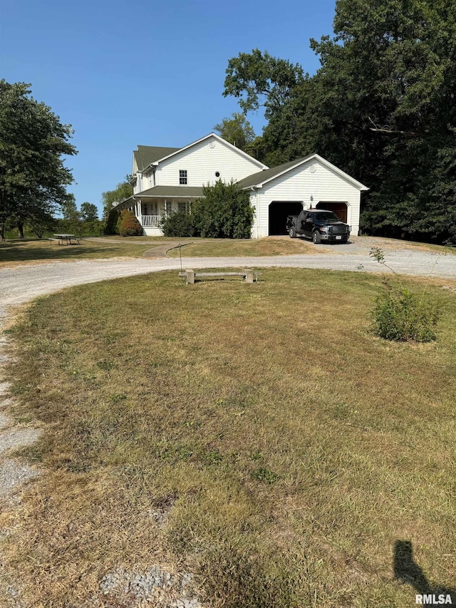 view of front facade featuring a garage, a front yard, and a carport