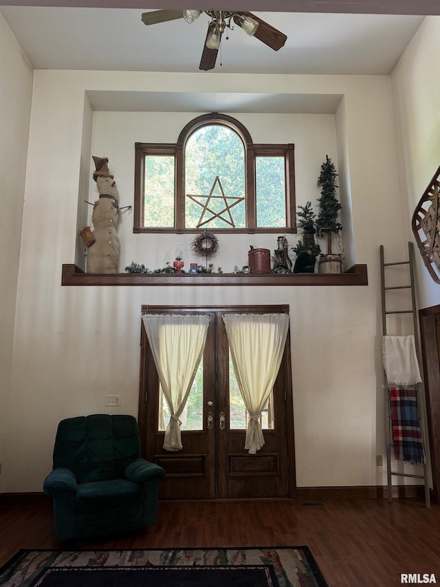 interior space with hardwood / wood-style flooring, ceiling fan, and french doors