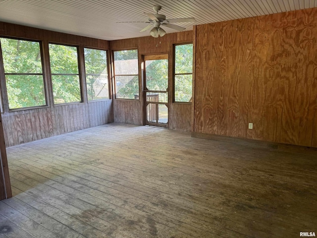 unfurnished sunroom featuring ceiling fan