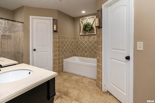 bathroom featuring vanity and tile walls