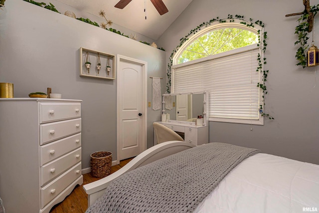 bedroom featuring hardwood / wood-style flooring, ceiling fan, and lofted ceiling