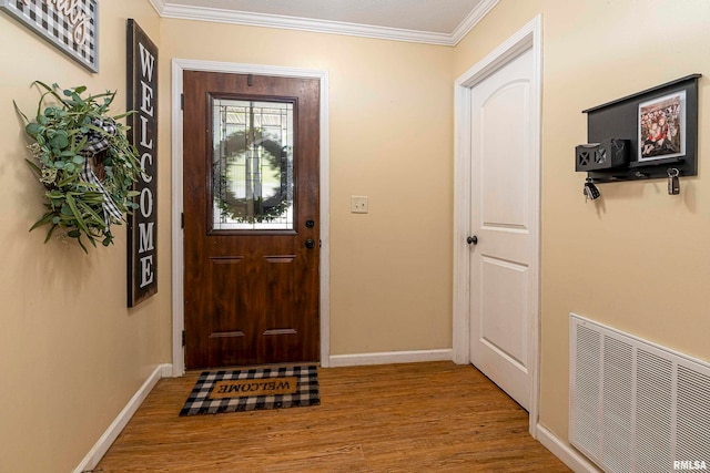 foyer with light wood-type flooring and ornamental molding