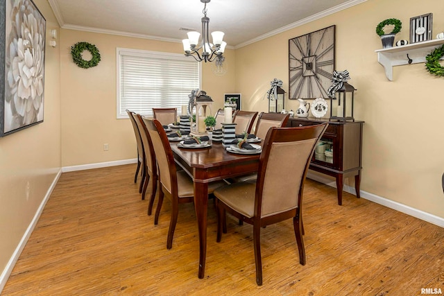 dining room featuring ornamental molding, a notable chandelier, and light wood-type flooring