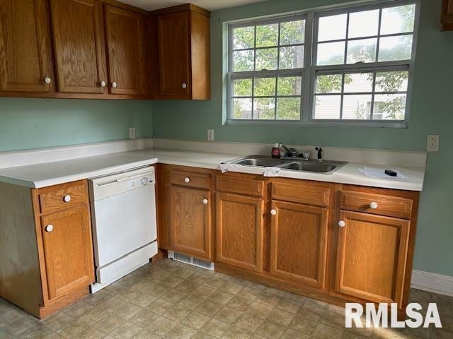 kitchen featuring white dishwasher and sink