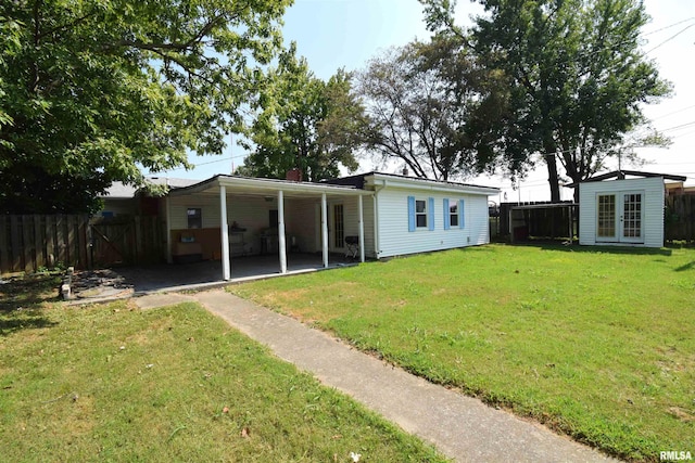 rear view of property with a lawn