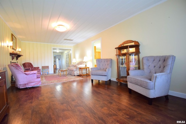 living area featuring dark hardwood / wood-style floors, crown molding, and wooden ceiling