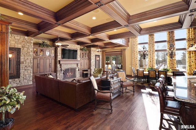 living room featuring ceiling fan, beamed ceiling, coffered ceiling, a large fireplace, and dark hardwood / wood-style flooring