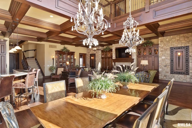 dining room with an inviting chandelier, beamed ceiling, coffered ceiling, and hardwood / wood-style floors