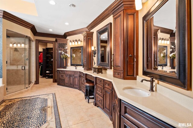 bathroom with tile patterned floors, walk in shower, vanity, and crown molding