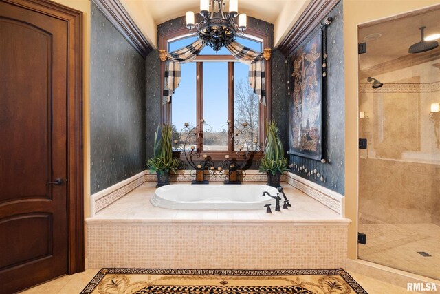 bathroom with a notable chandelier, tile patterned flooring, and independent shower and bath