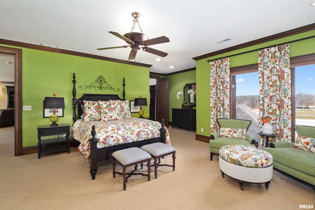 carpeted bedroom with ceiling fan and ornamental molding