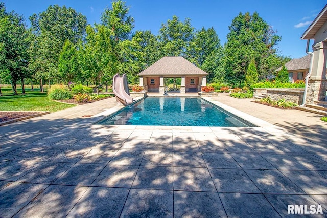 view of pool featuring a patio and a water slide