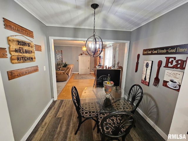 dining space with a notable chandelier, crown molding, and dark wood-type flooring