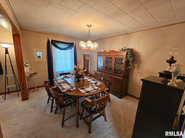 carpeted dining space with a chandelier