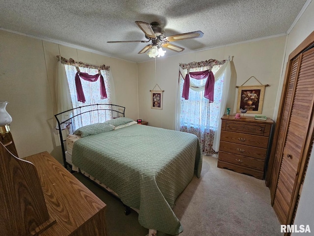 bedroom with light carpet, a closet, multiple windows, and ceiling fan