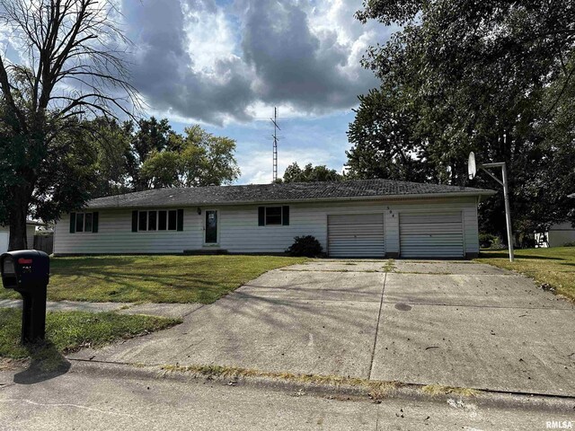 single story home featuring a garage and a front lawn