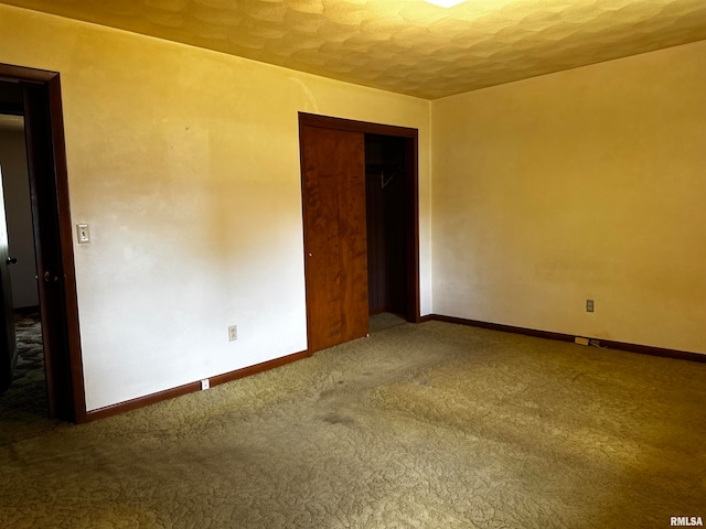 spare room with a textured ceiling and carpet