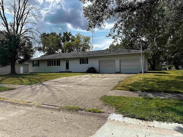 ranch-style house featuring a garage and a front lawn