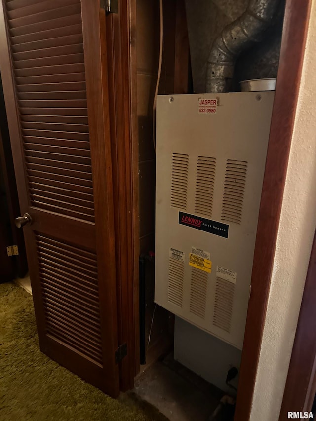 utility room featuring heating unit