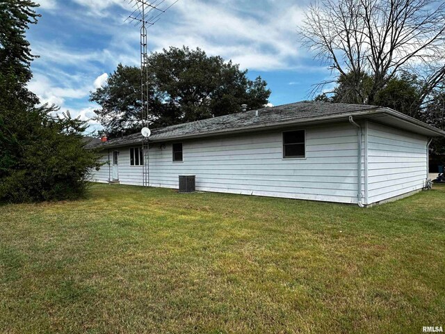 rear view of house featuring a yard