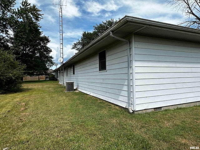 view of home's exterior with a lawn and cooling unit