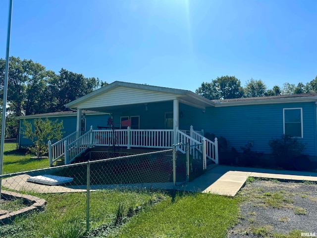 back of house with a lawn