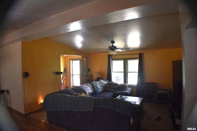 living room featuring ceiling fan and vaulted ceiling