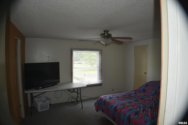 bedroom with a textured ceiling, carpet, and ceiling fan