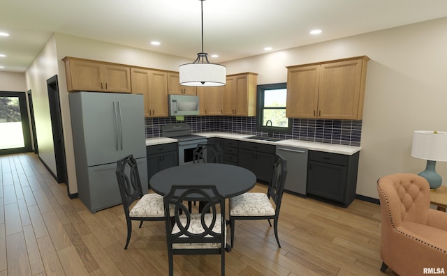 kitchen with backsplash, stainless steel appliances, light hardwood / wood-style flooring, decorative light fixtures, and sink