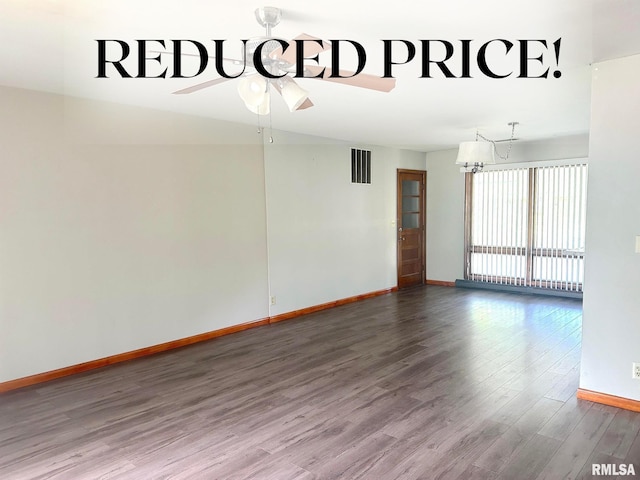 empty room featuring hardwood / wood-style floors and ceiling fan with notable chandelier