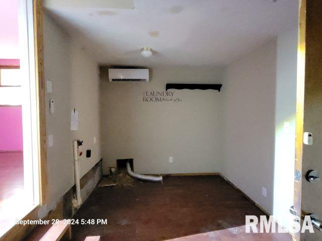 empty room featuring an AC wall unit