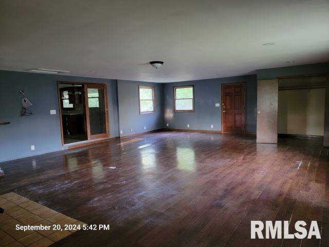 unfurnished living room with dark hardwood / wood-style flooring